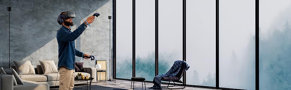 Man wears a VIVE Pro 2 headset in front of SteamVR Base Stations on tri-pod stands